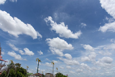 Low angle view of trees and building against sky