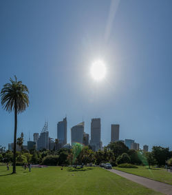 Scenic view of park on sunny day against sky