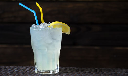 Close-up of lemonade in glass on table at home