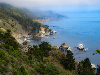 High angle view of sea and mountains against sky