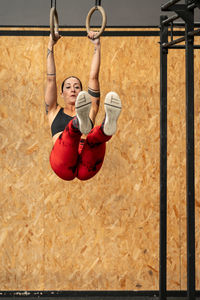 Rear view of woman exercising in playground