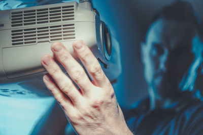 Man holding projector in cinema 