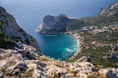 High angle view of rocks on sea shore against sky