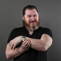 Portrait of smiling mid adult man against gray background