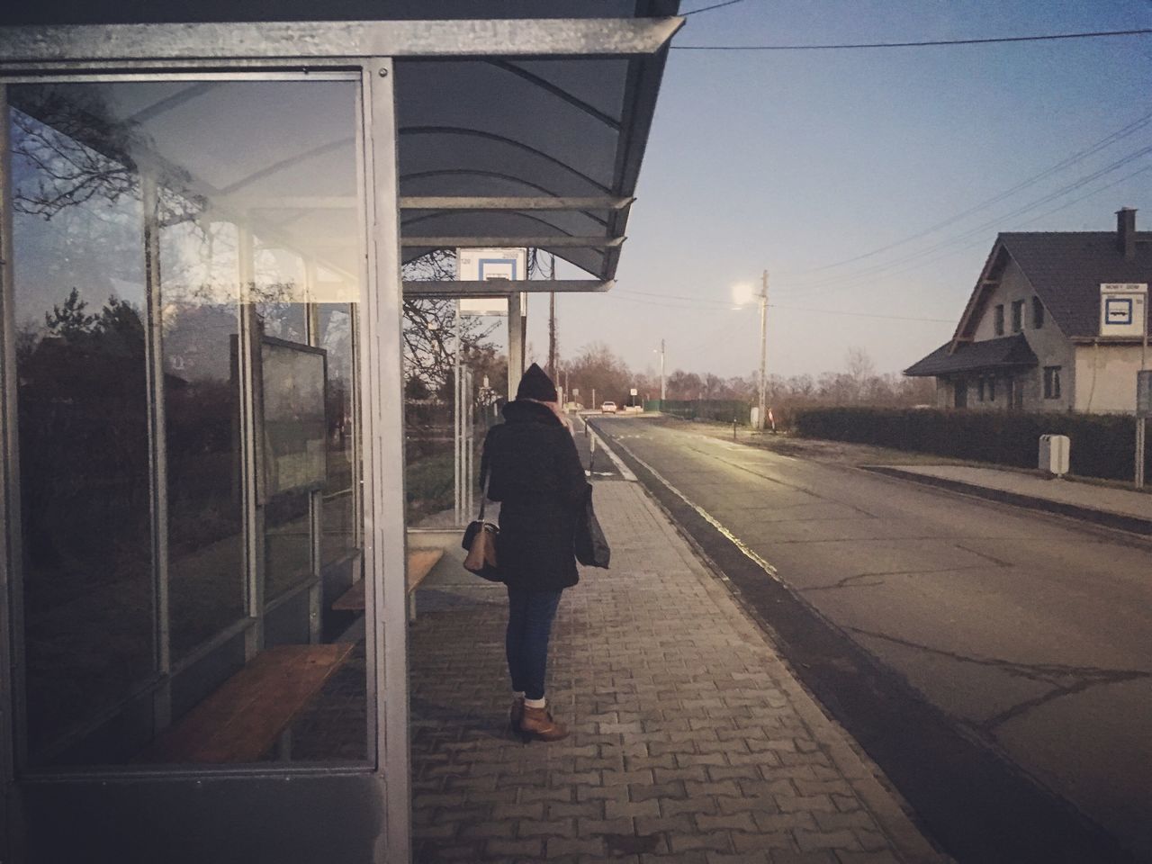 full length, one person, rear view, one woman only, walking, adults only, the way forward, people, building exterior, built structure, real people, women, sky, adult, only women, outdoors, architecture, warm clothing, day