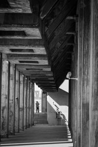 Man walking in corridor of building