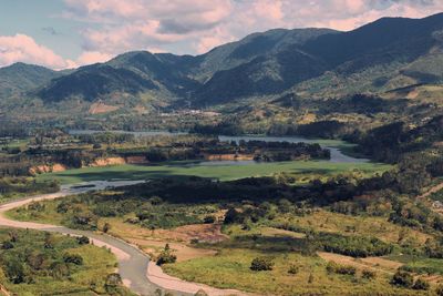 Scenic view of landscape and mountains against sky