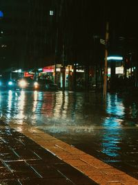 Wet street in city during rainy season at night