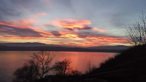 Scenic view of calm lake at sunset