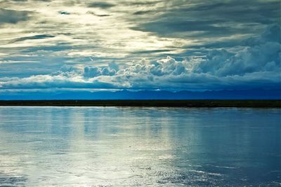 Scenic view of sea against cloudy sky