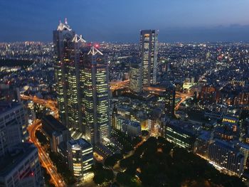 High angle view of illuminated buildings against sky at night