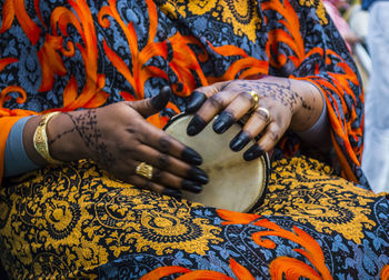 Midsection of woman playing equipment