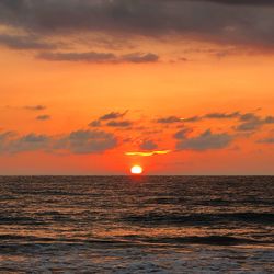 Scenic view of sea against romantic sky at sunset