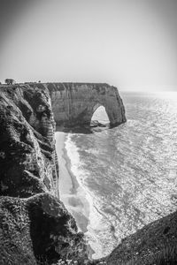 Scenic view of rock formation in sea against clear sky