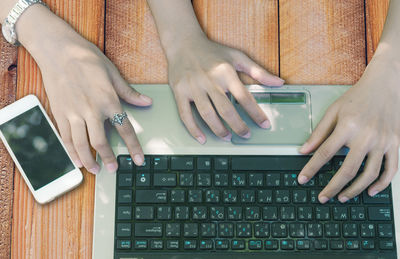 Midsection of woman using mobile phone