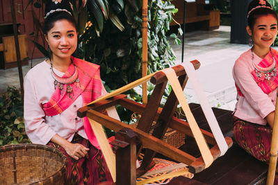 Portrait of smiling girl sitting outdoors