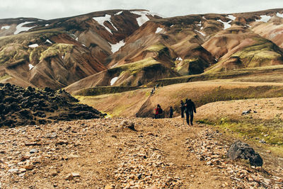 People hiking on mountain during winter