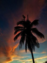 Low angle view of silhouette palm tree against romantic sky