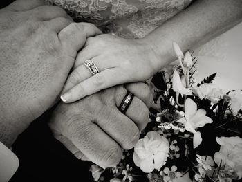 Close-up of hands touching flowers