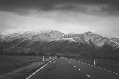 Road amidst mountains against sky