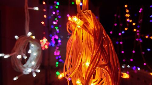 Defocused image of illuminated christmas lights at night