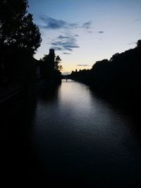 Scenic view of river against sky at sunset