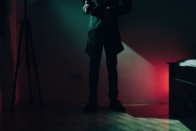 Low section of man standing on floor at home