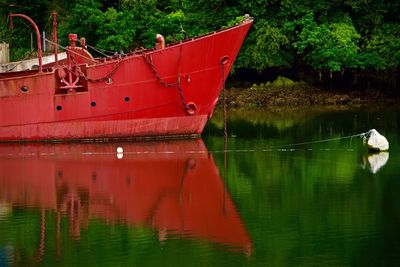 Reflection of fishing boat in river