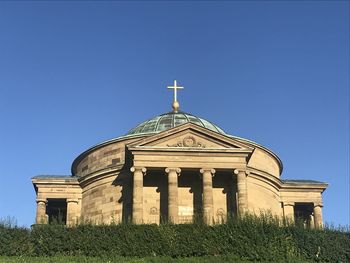 Low angle view of historical building against clear blue sky