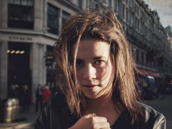 Portrait of beautiful young woman in city