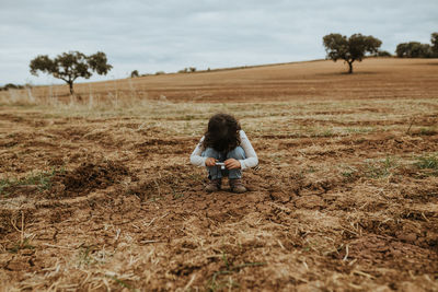 Cute girl photographing soil