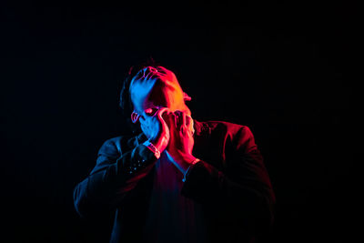 Close-up of man against black background