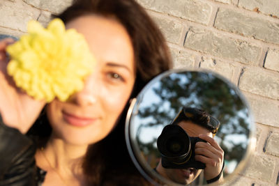 Portrait of woman photographing