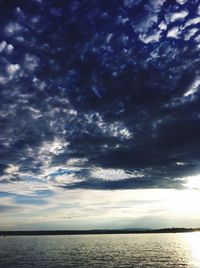 Scenic view of sea against cloudy sky