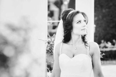 Portrait of a young woman looking away outdoors