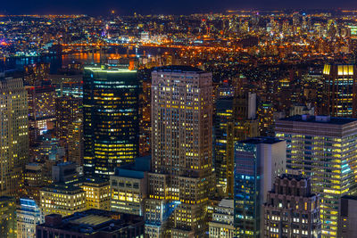 High angle view of illuminated buildings in city at night