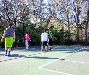 Group of people playing basketball court