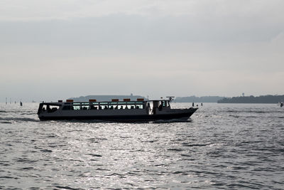 Boat sailing on sea against sky