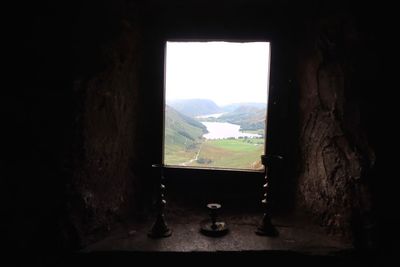 Scenic view of mountains seen through window