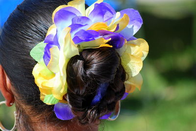 Rear view of woman with pink flower