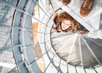 Portrait of woman standing on spiral staircase