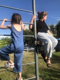 Full length of siblings playing on the sky