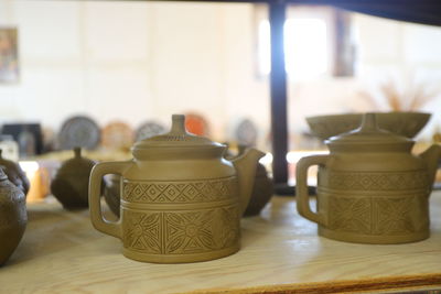 Close-up of wine glasses on table pottery teapot clay ornament handmade 