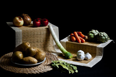 Close-up of vegetables on table against black background