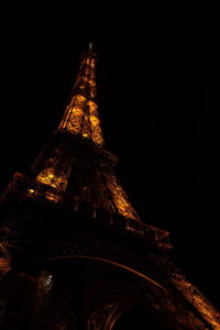 Low angle view of illuminated building against sky at night