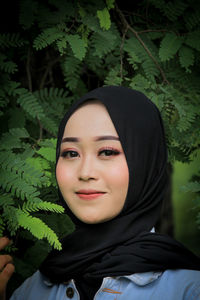 Portrait of a young woman with plants