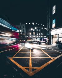 Illuminated city street at night