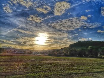 Scenic view of field against sky during sunset
