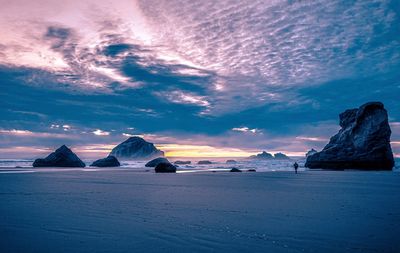 Scenic view of facerock against sky during sunset