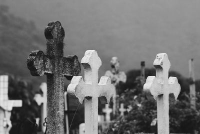 Close-up of cross on cemetery